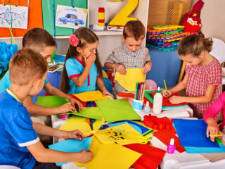 Group of children engaging in colorful craft activities in a classroom