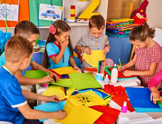 Group of children engaging in colorful craft activities in a classroom