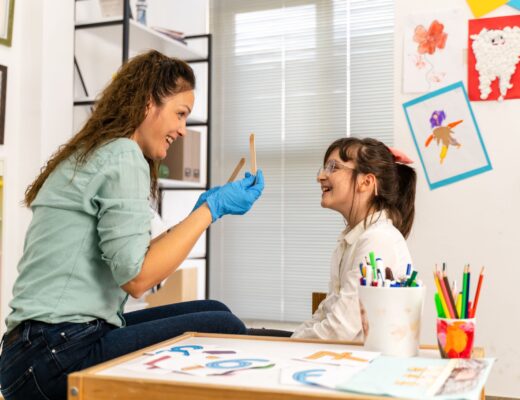 Happy therapist engaging with young girl during an art therapy session