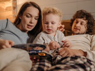 Parents reading a bedtime story to their young child