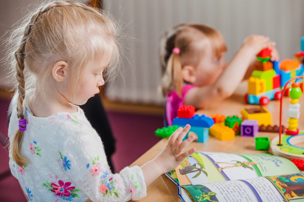 Two young children engaging in occupational therapy activities, enhancing their sensory processing skills through structured play and learning exercises.