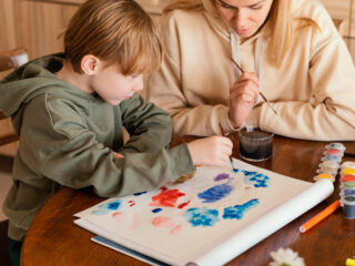 Therapist doing art based therapy with autistic child