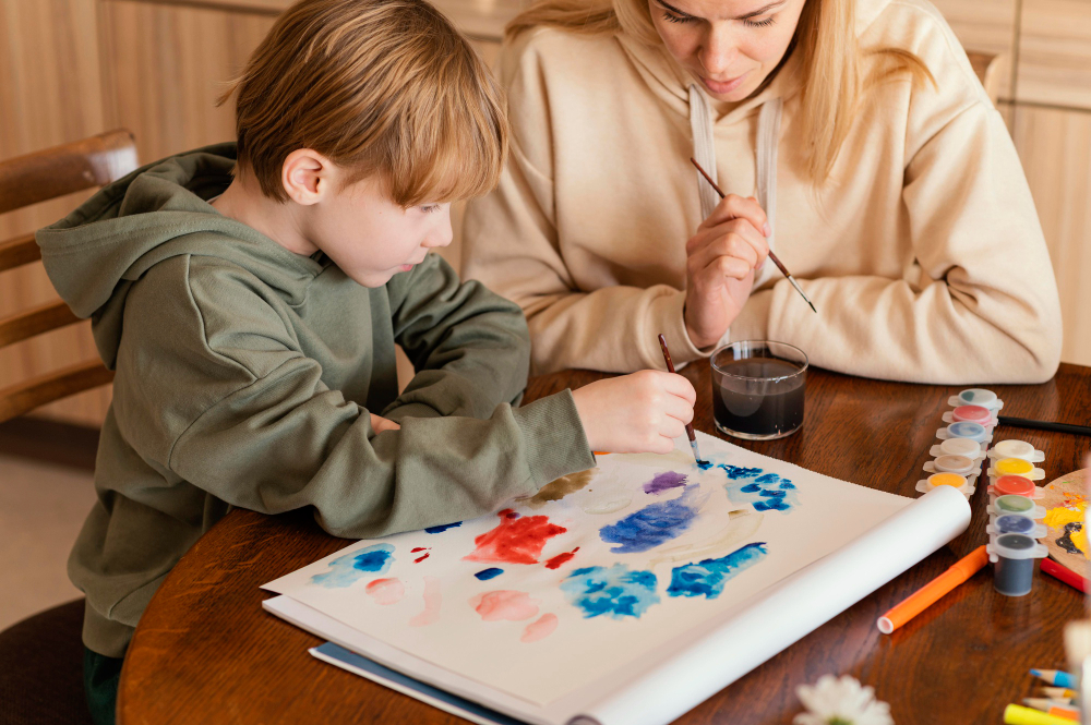 Therapist doing art based therapy with autistic child