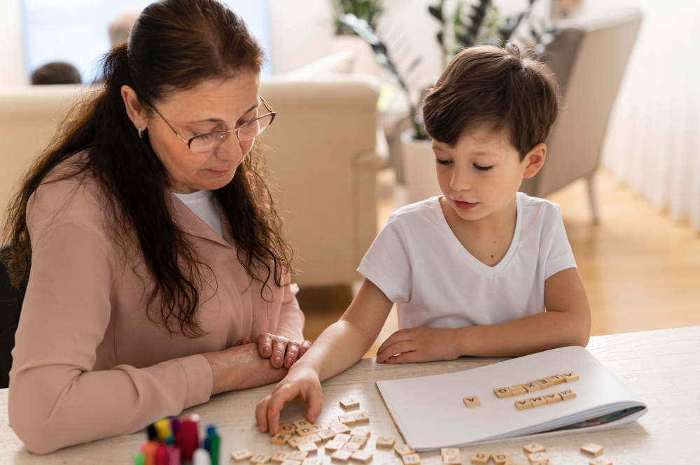 The image shows a young boy working with a teacher using letter tiles, highlighting the personalized support in special education for children with autism to develop key skills.