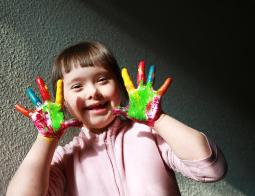 kid with down syndrome playing with colors