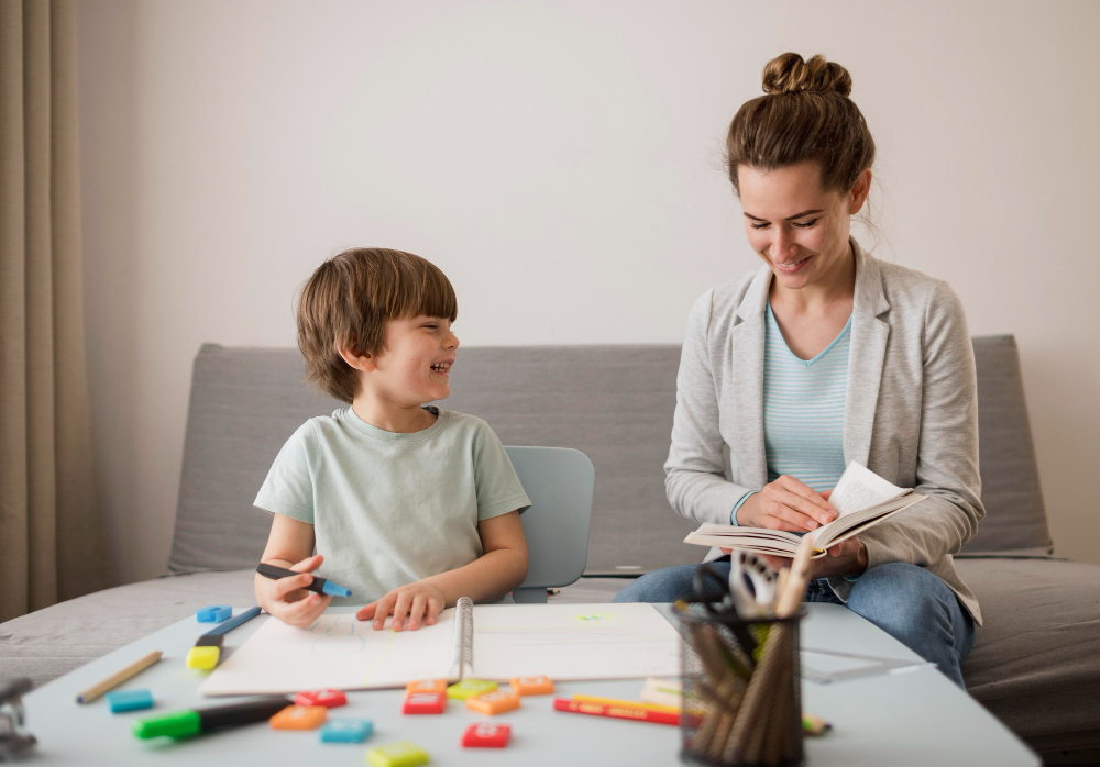 A smiling child engages with a supportive adult in a learning environment, reflecting positive autism therapy and educational support.