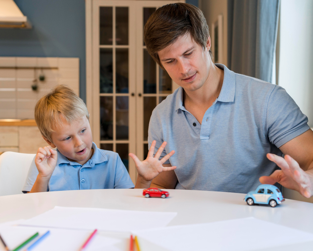 The image shows a father engaging with his young autistic son through play with toy cars, highlighting the importance of parental support and interaction in managing autism-related challenges.