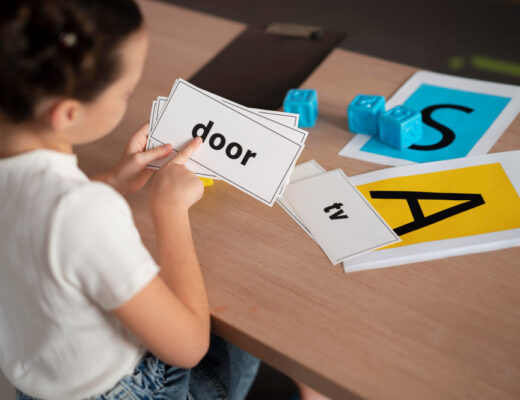 A young child is working with flashcards displaying simple words like "door" and "tv" to support dyslexia learning.