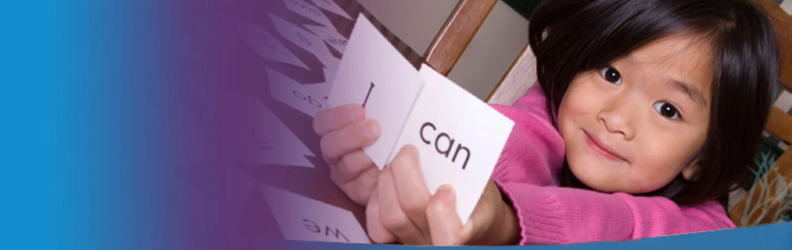 Young girl holding 'I can' cards